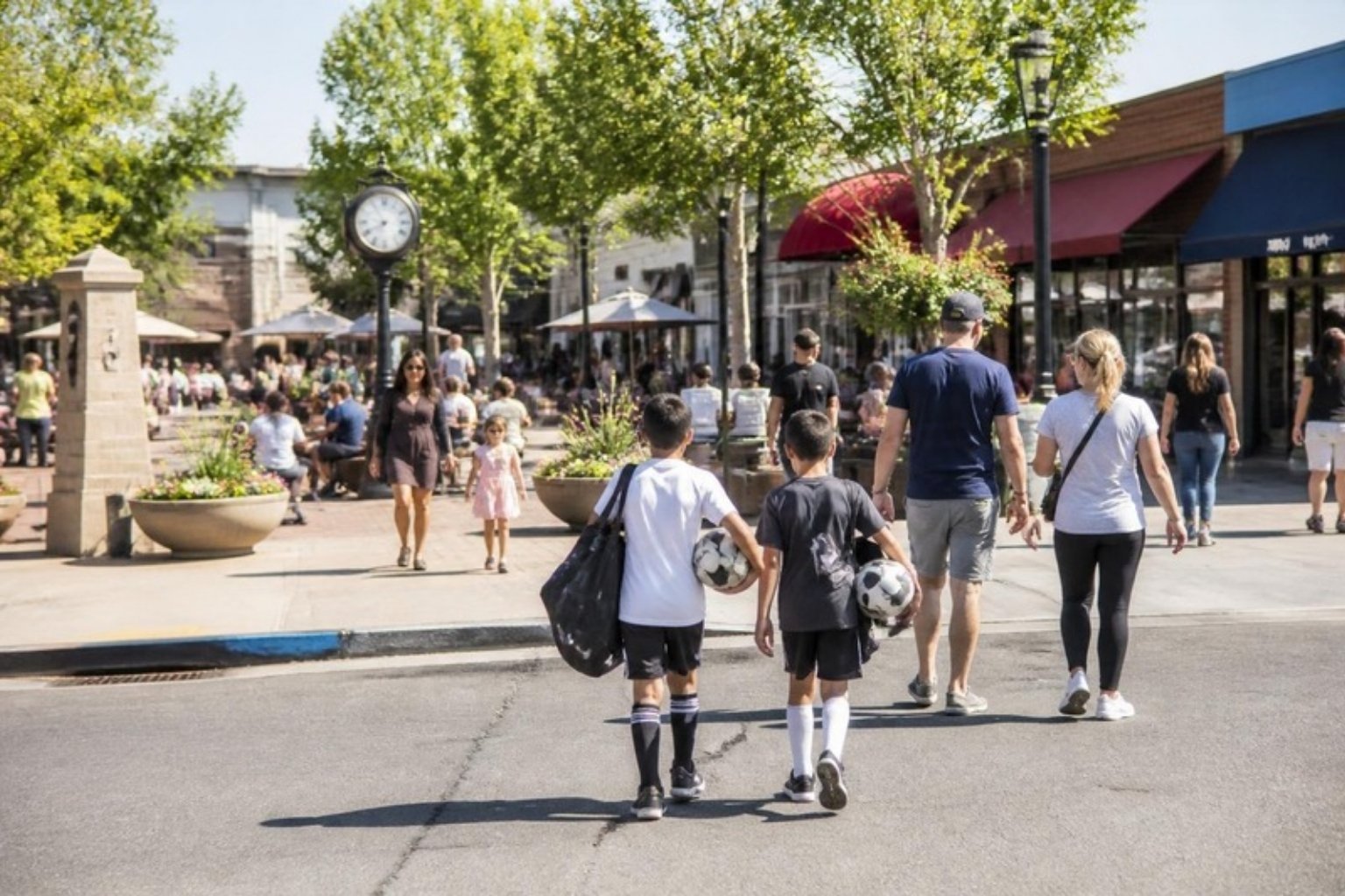 Families with kids carrying soccer gear in a suburban town center in Kingstowne, Virginia